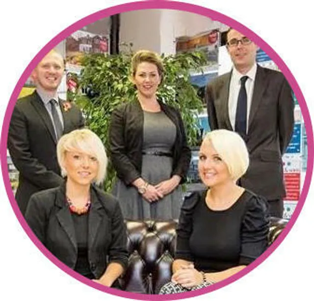 Five members of an estate agency team in a branch office